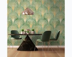 a dining room with green chairs and a table in front of an art deco wallpaper