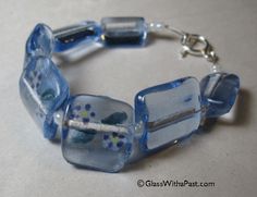 a bracelet made out of glass beads on a table