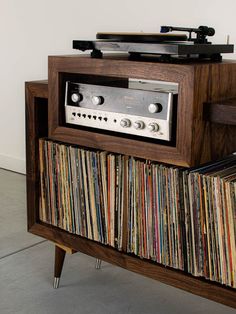 an old record player is sitting on top of a cabinet