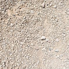 rocks and gravel on the side of a road with no cars or people in it