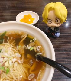 a bowl of ramen with chopsticks next to it