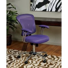 a purple office chair sitting on top of a wooden floor next to a painting and rug