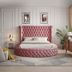 a pink bed sitting in the middle of a bedroom