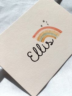 a card with the word hello written on it and a rainbow painted in black ink