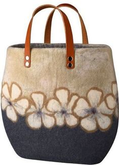 a handbag with flowers painted on the side and leather handles, sitting in front of a white background