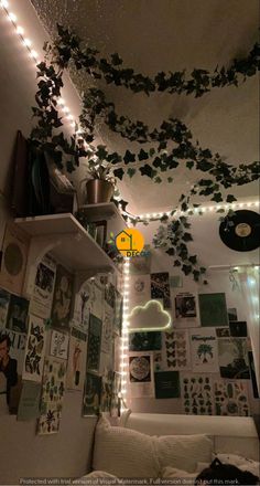 the ceiling is covered with plants and lights in this living room, which are decorated with vinyl records