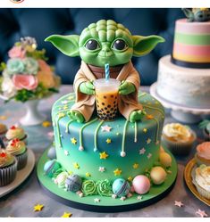 a star wars themed cake with a baby yoda holding a drink