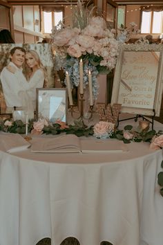 a table with flowers and pictures on it