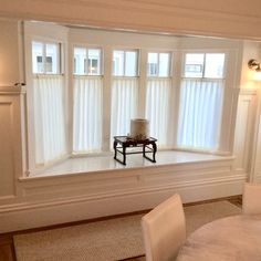 a living room filled with furniture and windows