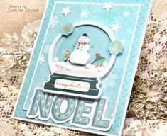 a card with a snow globe on it and the words noel written in white letters