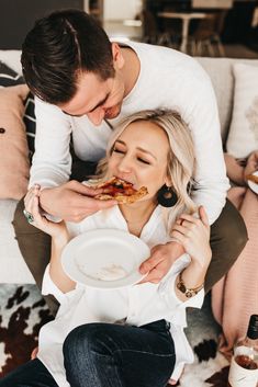 a man and woman are eating pizza together