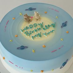 a birthday cake with two cats on top and the words happy birthday to you written in blue frosting