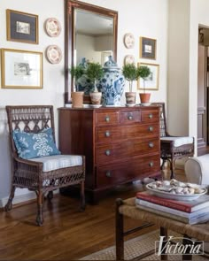 a living room filled with lots of furniture and pictures on the wall above it's mirror