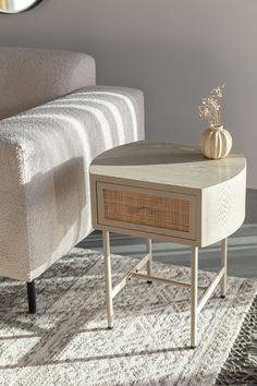 a living room scene with focus on the end table and sofa in the foreground