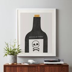 there is a poster on the wall with a skull and a wine bottle in it