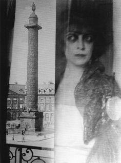 an old black and white photo of a woman in front of a tall tower with a clock on it