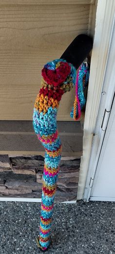 a colorful crocheted object hanging from the side of a door