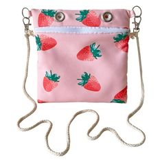 a pink bag with strawberries on it and a white string hanging from the front