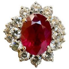 a large red and white diamond ring on a white background with the center surrounded by smaller diamonds