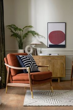 a living room filled with furniture and a painting on the wall