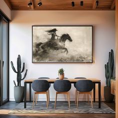 a black and white photo hangs above a dining room table