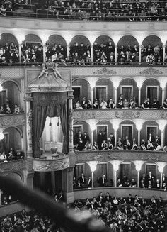 an auditorium full of people in the middle of a stage