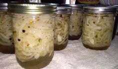 four jars filled with food sitting on top of a table