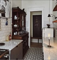 an old fashioned kitchen with black and white tile