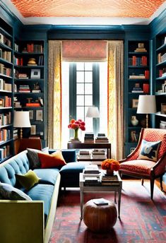 a living room filled with lots of furniture and bookshelves full of books on shelves