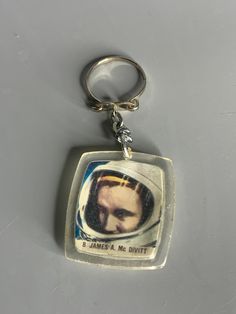 a keychain with an image of a man wearing a spacesuit on it