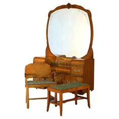 an antique dressing table with mirror and stools