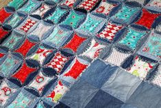 a blue and red patchwork quilt on the floor