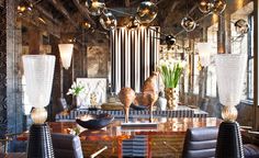 a dining room table with chairs and chandelier hanging from it's ceiling