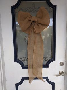 a burlock bow hangs on the front door of a home in an old town