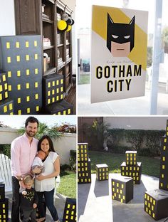 some people are posing for pictures in front of batman city signs and other things that look like they have been made out of cardboard boxes