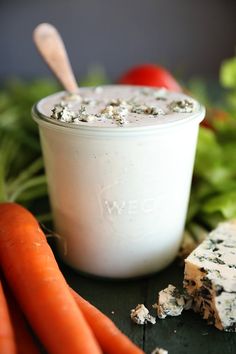 carrots, celery and cheese are on the table next to a bowl