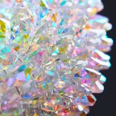 a close up view of many different colored diamonds