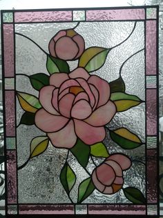 a stained glass window with pink flowers on it