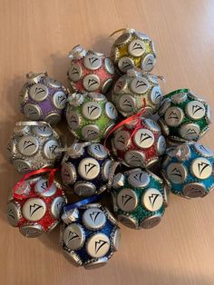 a pile of metal dices sitting on top of a wooden table