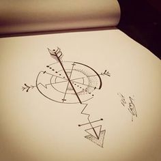 a drawing of an arrow and compass on paper