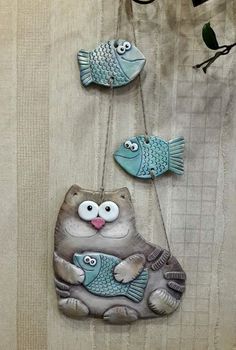 three ceramic fish hanging on a wall