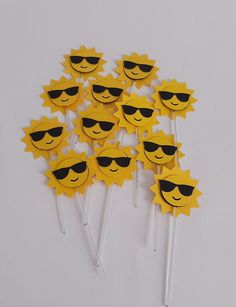 a bunch of smiley face lollipops with sunglasses on them