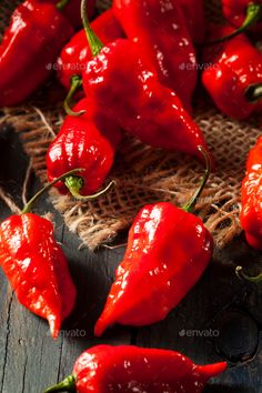 red hot peppers on a wooden table with scissors and burlock stock photo 1047982