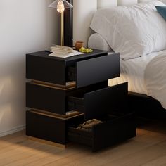 a night stand with drawers in front of a bed