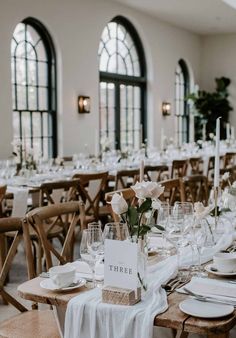 the tables are set with white plates and place settings