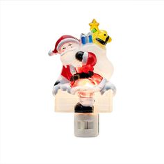 a light up santa clause on top of a christmas tree ornament with a star