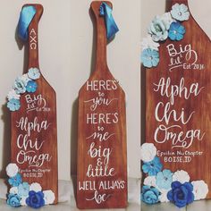 three wooden paddles decorated with blue and white flowers