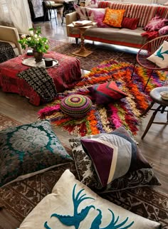 a living room filled with lots of colorful pillows