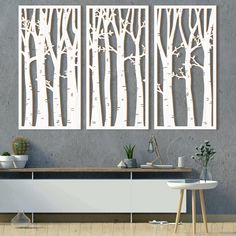 two white trees are hanging on the wall