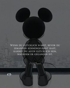 a mickey mouse standing in front of a window with a quote written on the side